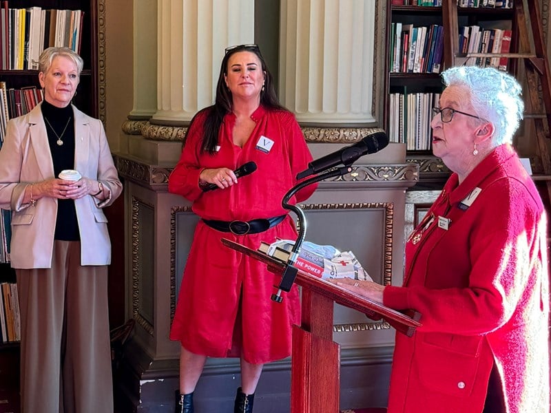 Veteran Red Cross volunteer Judith McCarthy watched on by Legislative Assembly Speaker Maree Edwards and Red Cross Victorian Director Nichola Krey.